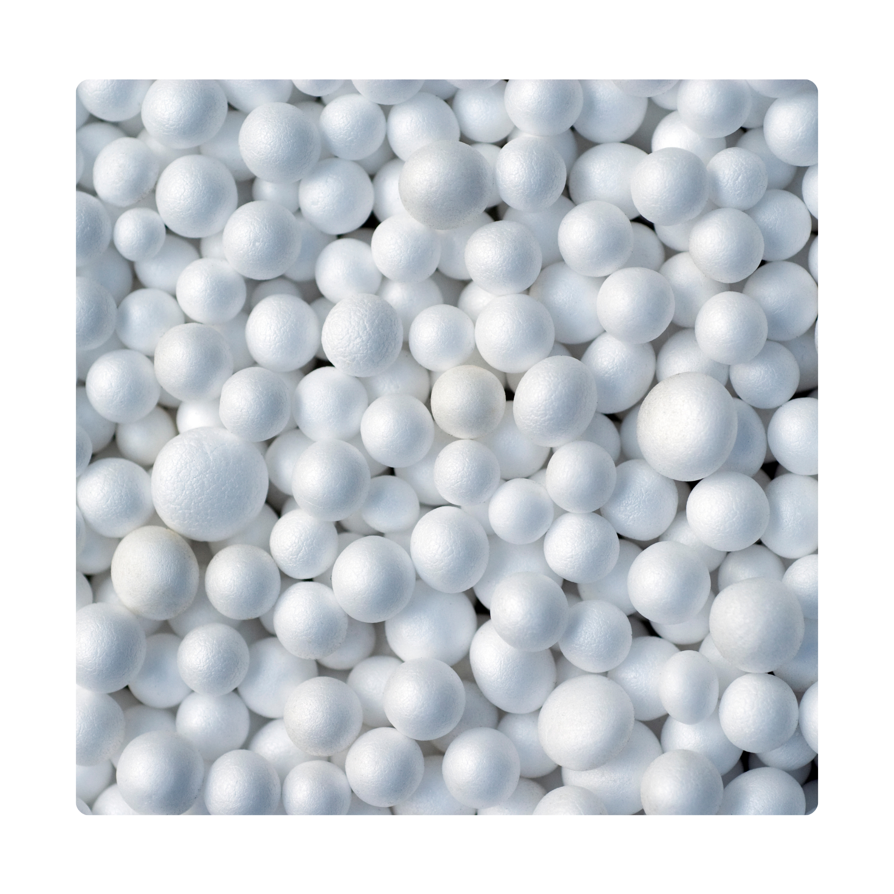 A high-angle, detailed macro photograph shows a dense collection of smooth, white expanded polystyrene (EPS) beads, various sized spherical shapes filling the square frame. The beads have a slight sheen and are closely packed against a dark, out-of-focus background
